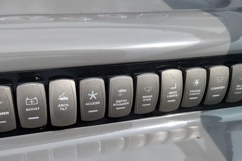 Slide: The Image of Control panel of a 2006 Doral Monticello 250 boat with labeled switches. - 43