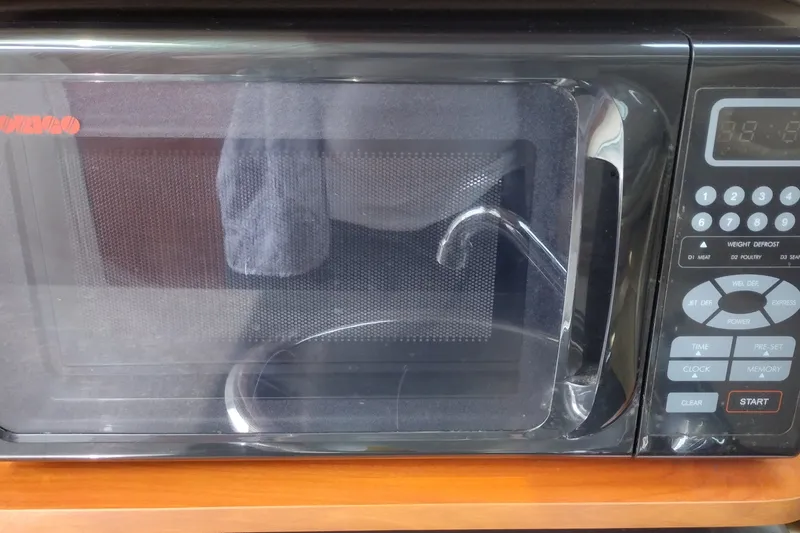 Slide: The Image of Microwave oven inside a 2006 Doral Monticello 250 boat kitchen area. - 28