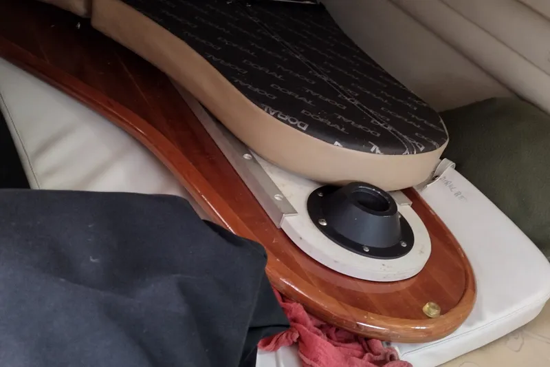 Slide: The Image of 2006 Doral Monticello 250 boat interior with wooden table and cushion. - 37