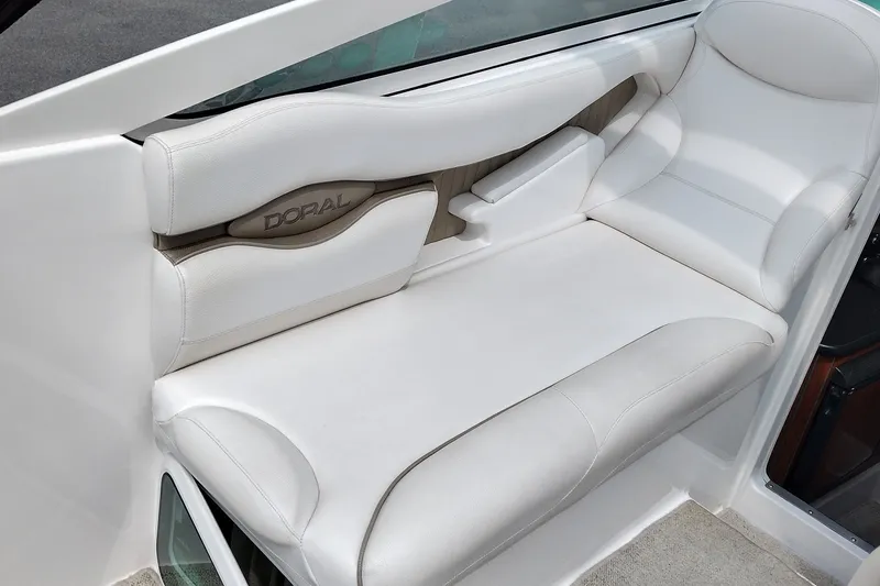 Slide: The Image of 2006 Doral Monticello 250 boat interior with white cushioned seating. - 17