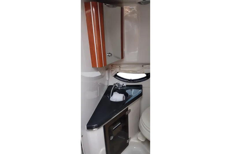 Slide: The Image of Interior of 2006 Doral Monticello 250 boat bathroom with sink and cabinet. - 35