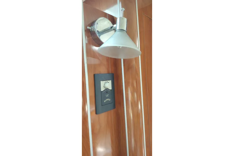 Slide: The Image of Wall-mounted light fixture and control panel in 2006 Doral Monticello 250 boat interior. - 31