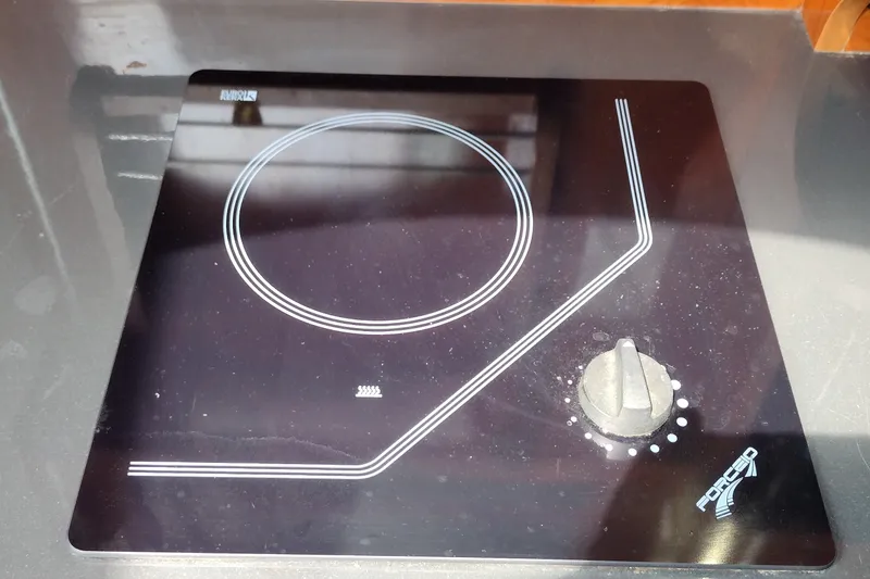 Slide: The Image of Ceramic cooktop on a 2006 Doral Monticello 250 boat, featuring a single burner and control knob. - 26
