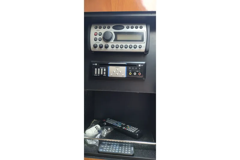 Slide: The Image of 2006 Doral Monticello 250 boat stereo system with control panel and remote controls. - 30