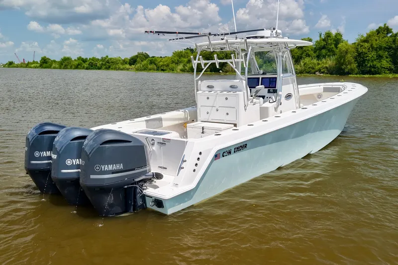 Slide: The Image of 2016 Contender 35 ST boat with triple Yamaha engines on a calm river. - 4