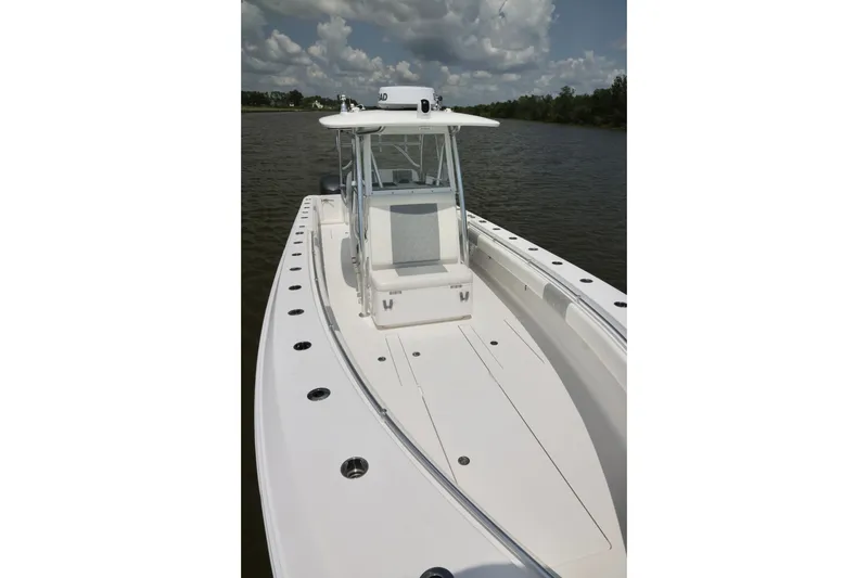 Slide: The Image of 2016 Contender 35 ST boat on calm water under cloudy sky. - 11