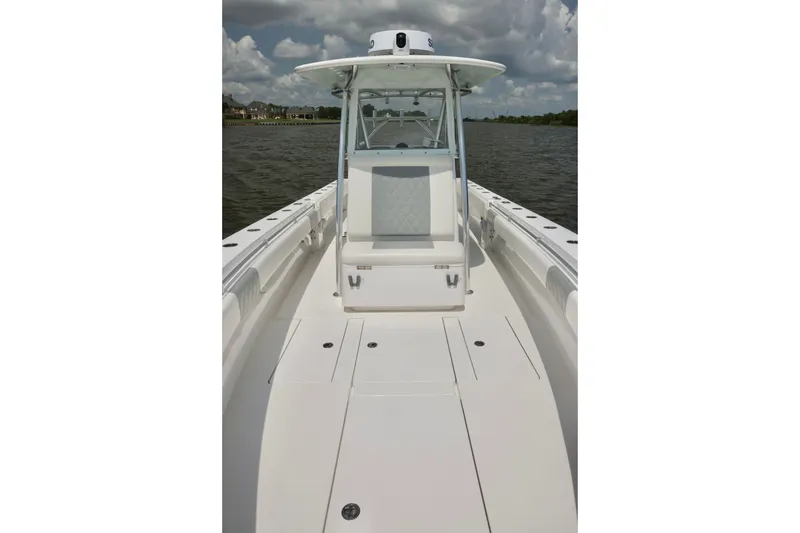 Slide: The Image of 2016 Contender 35 ST boat on water, featuring sleek white deck and center console. - 10