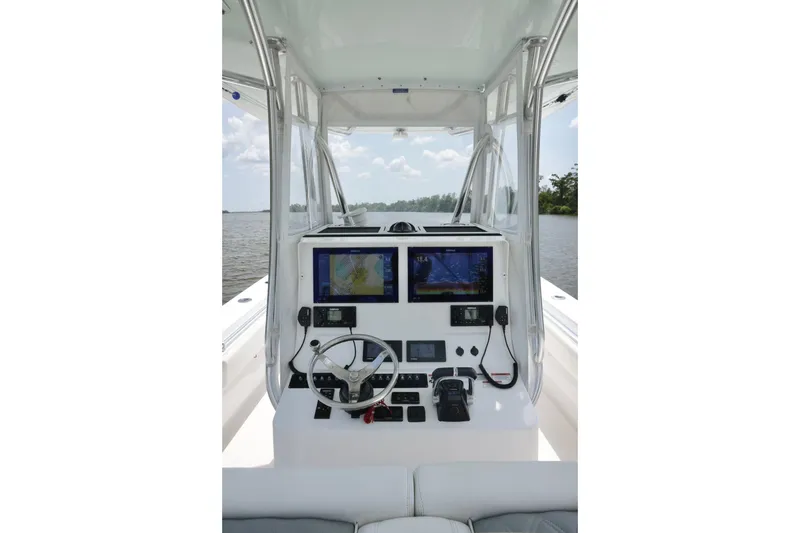 Slide: The Image of 2016 Contender 35 ST boat helm with dual navigation screens and steering wheel. - 16
