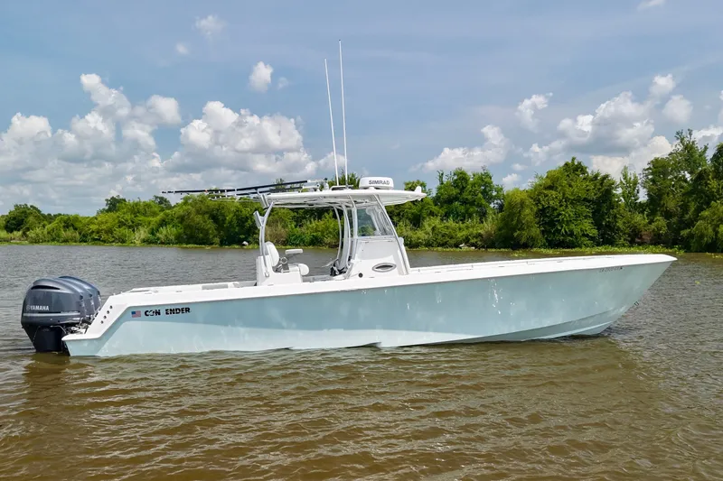 Slide: The Image of 2016 Contender 35 ST boat on a calm river with lush green background. - 3