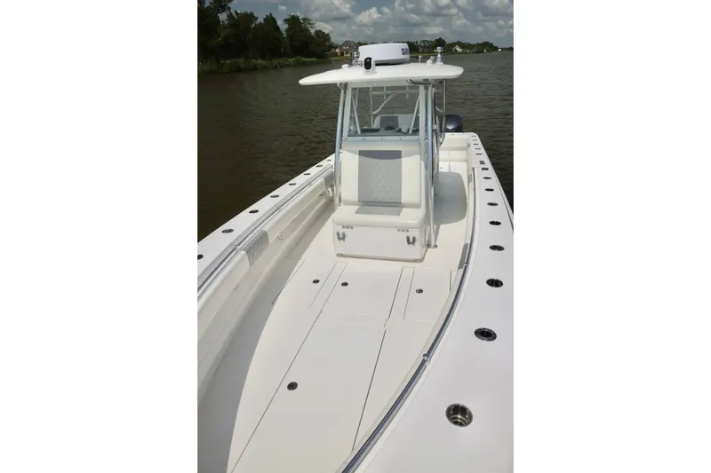 Slide: The Image of 2016 Contender 35 ST boat on calm water, featuring spacious deck and sleek design. - 12