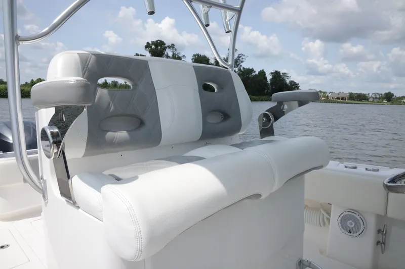 Slide: The Image of 2016 Contender 35 ST boat seating with armrests, on a calm water backdrop. - 20