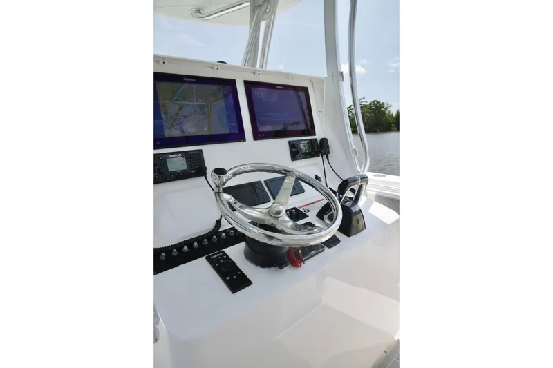 Slide: The Image of Helm of 2016 Contender 35 ST boat with dual navigation screens and steering wheel. - 17