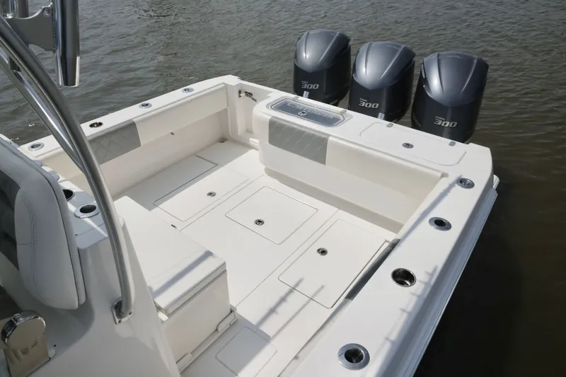 Slide: The Image of 2016 Contender 35 ST boat with triple 300 horsepower engines on calm water. - 22