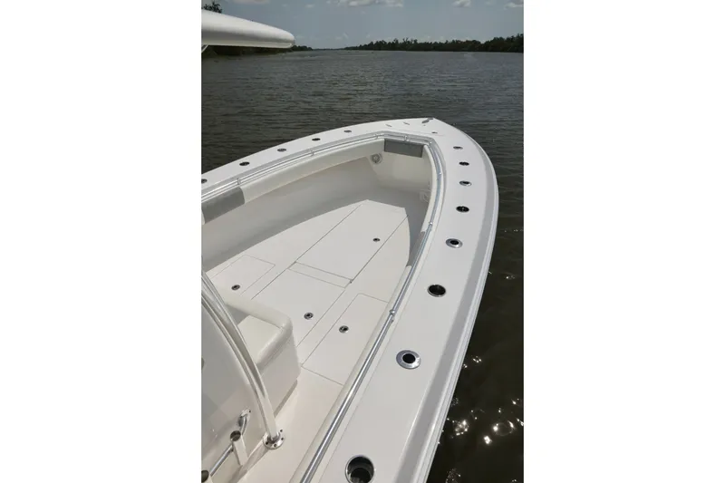 Slide: The Image of 2016 Contender 35 ST boat deck on calm water, showcasing sleek design and spacious layout. - 14