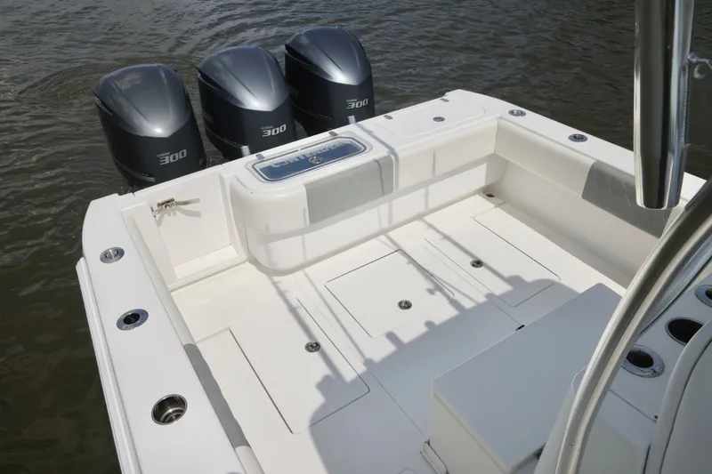 Slide: The Image of 2016 Contender 35 ST boat with triple 300 horsepower engines on calm water. - 13
