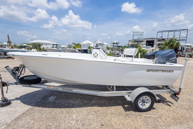 Slide: The Image of 2015 Sportsman Island Reef 17 Center Console boat on trailer, outdoor dealership setting. - 11