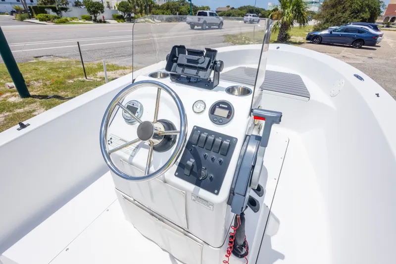 Slide: The Image of 2015 Sportsman Island Reef 17 Center Console boat interior with steering wheel and controls. - 22