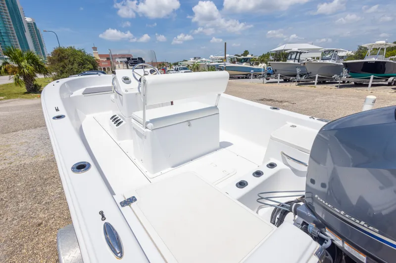 Slide: The Image of 2015 Sportsman Island Reef 17 Center Console boat, parked outdoors under a sunny sky. - 18