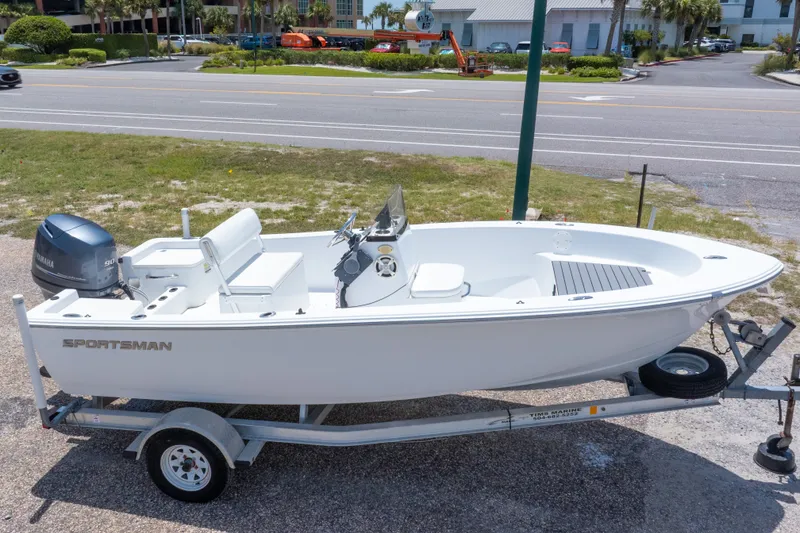 Slide: The Image of 2015 Sportsman Island Reef 17 Center Console boat on trailer, parked near a road. - 2