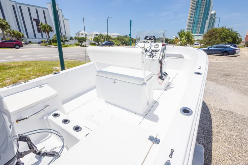 Slide: The Image of 2015 Sportsman Island Reef 17 Center Console boat parked near modern buildings. - 17