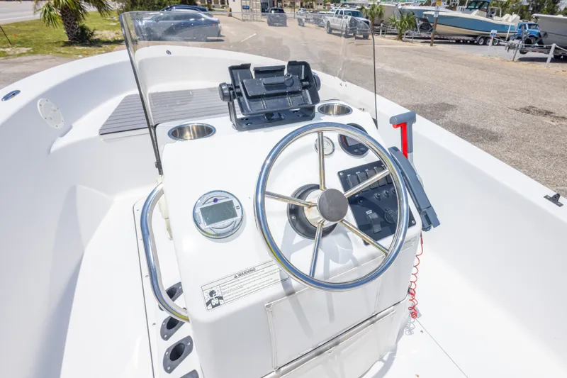 Slide: The Image of 2015 Sportsman Island Reef 17 Center Console boat interior with steering wheel and controls. - 21