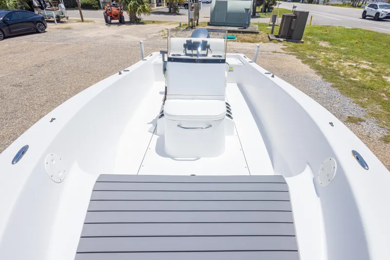 Slide: The Image of 2015 Sportsman Island Reef 17 Center Console boat, white interior, parked outdoors. - 26