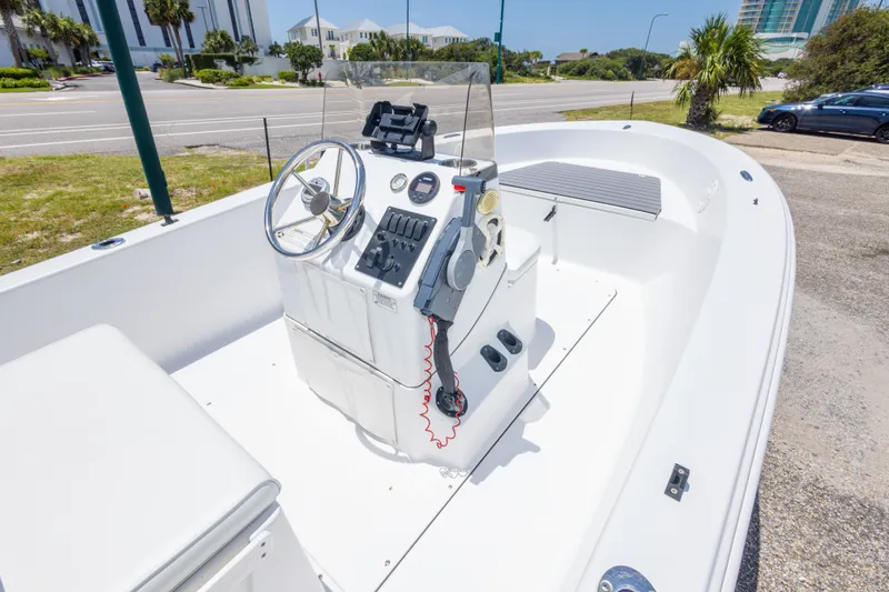 Slide: The Image of 2015 Sportsman Island Reef 17 Center Console boat, featuring steering wheel and control panel. - 20