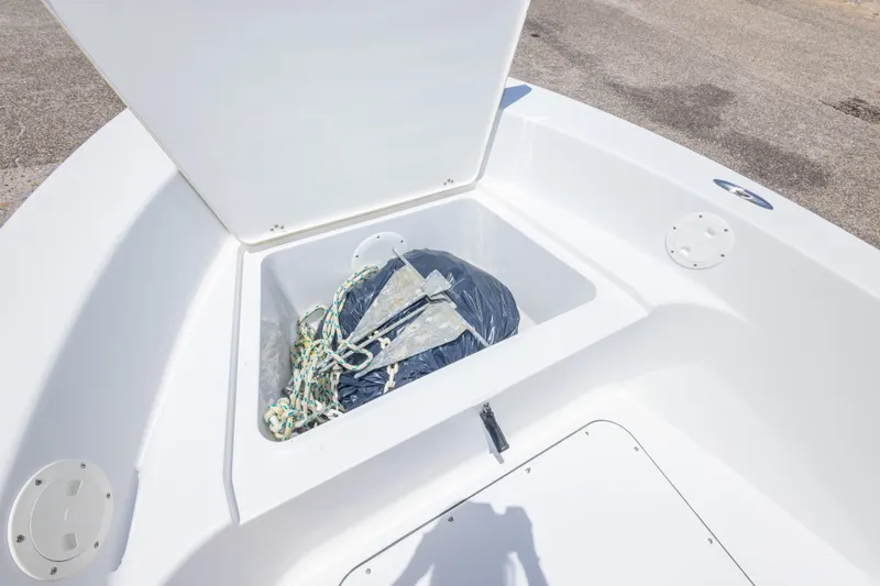 Slide: The Image of 2015 Sportsman Island Reef 17 Center Console boat storage compartment with anchor and rope. - 24
