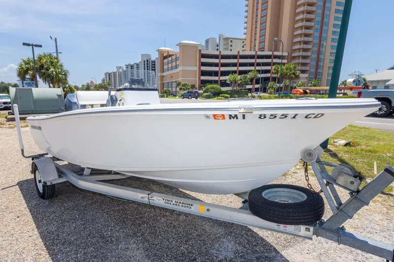 Slide: The Image of 2015 Sportsman Island Reef 17 Center Console boat on trailer, urban background. - 10