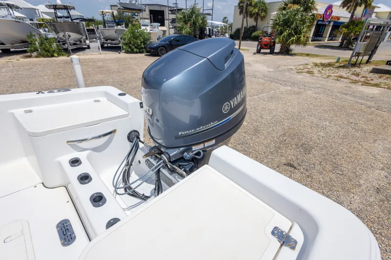 Slide: The Image of 2015 Sportsman Island Reef 17 Center Console with Yamaha outboard motor in a marina setting. - 33