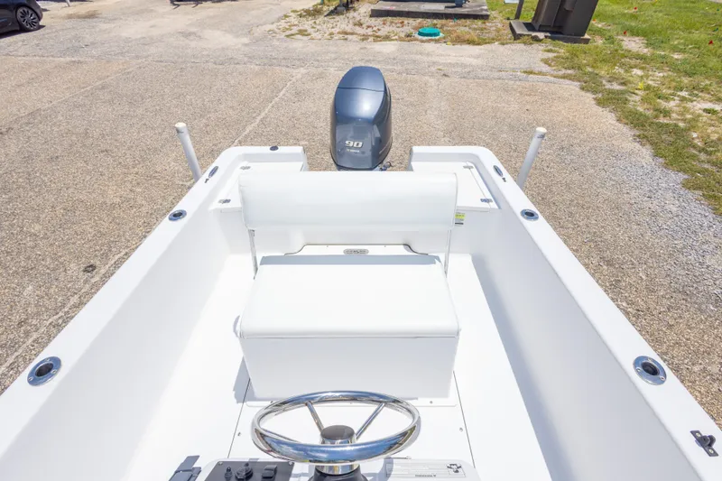 Slide: The Image of 2015 Sportsman Island Reef 17 Center Console boat interior with steering wheel and outboard motor. - 29
