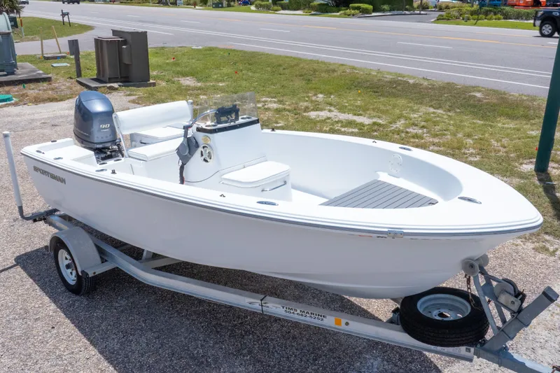 Slide: The Image of 2015 Sportsman Island Reef 17 Center Console boat on trailer, parked near a road. - 1