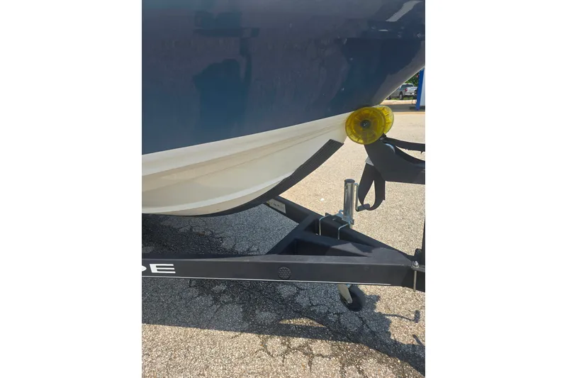 Slide: The Image of 2021 Tahoe 550 TF boat on trailer, close-up of hull and wheel. - 3