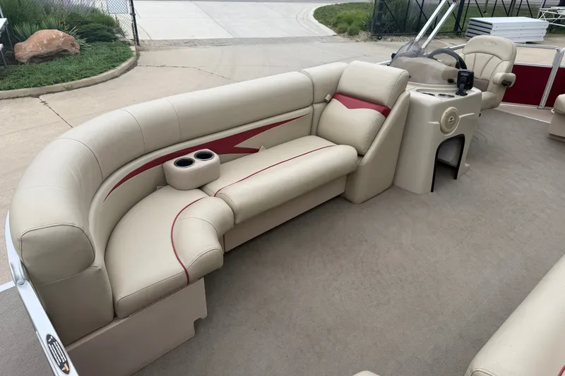 Slide: The Image of 2011 Harris Cruiser 220 boat interior with beige seating and cup holders. - 5