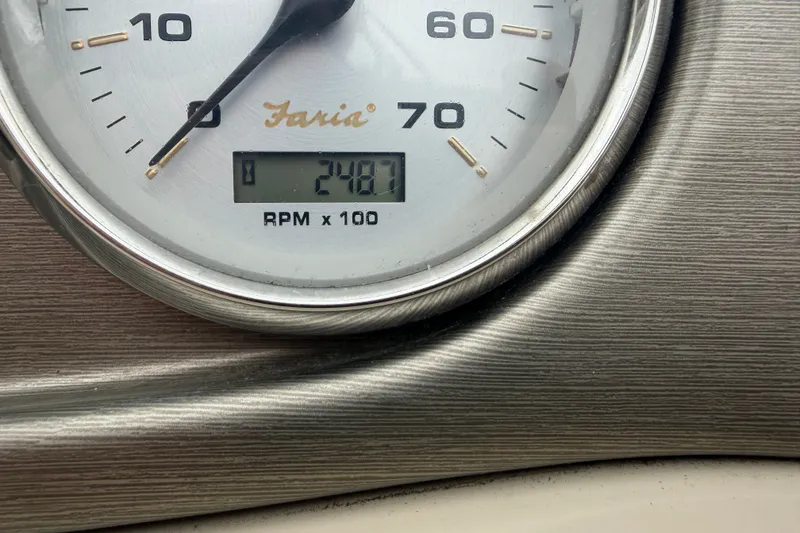 Slide: The Image of Close-up of a 2011 Harris Cruiser 220 tachometer displaying 2487 RPM. - 12