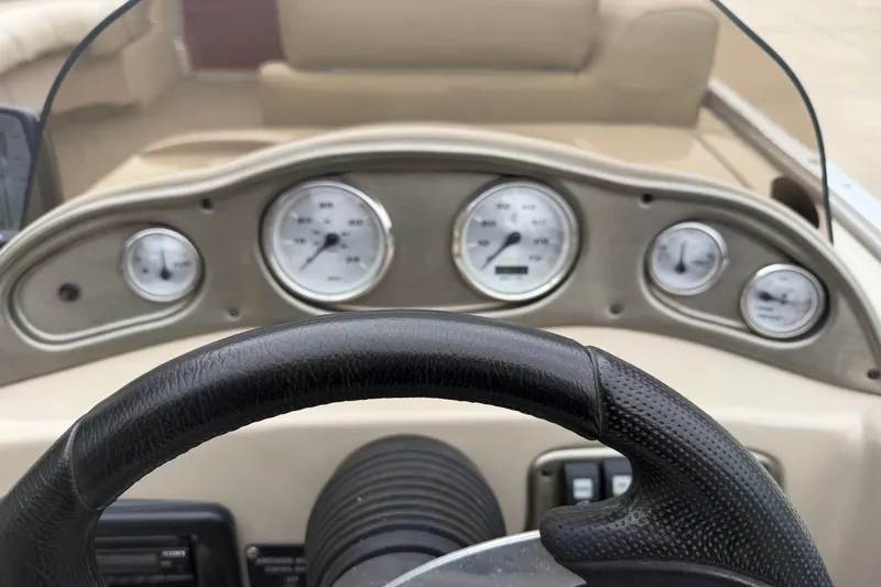 Slide: The Image of Steering wheel and dashboard of 2011 Harris Cruiser 220 boat. - 11