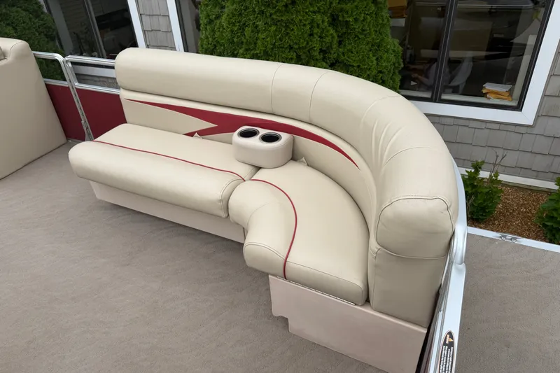 Slide: The Image of 2011 Harris Cruiser 220 boat seating with beige upholstery and cup holders. - 4