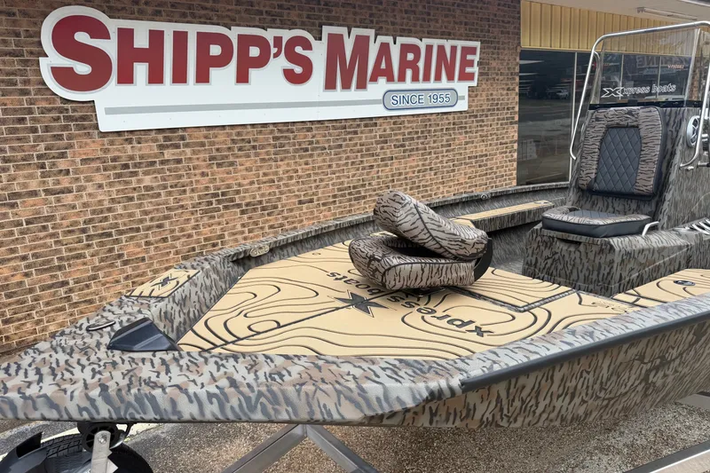 Slide: The Image of 2027 Xpress H20B Bay boat at Shipp's Marine, featuring camo design and seating. - 3