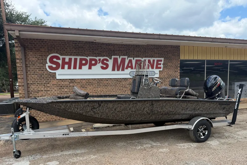 Slide: The Image of 2027 Xpress H20B Bay boat on trailer outside Shipp's Marine store. - 4