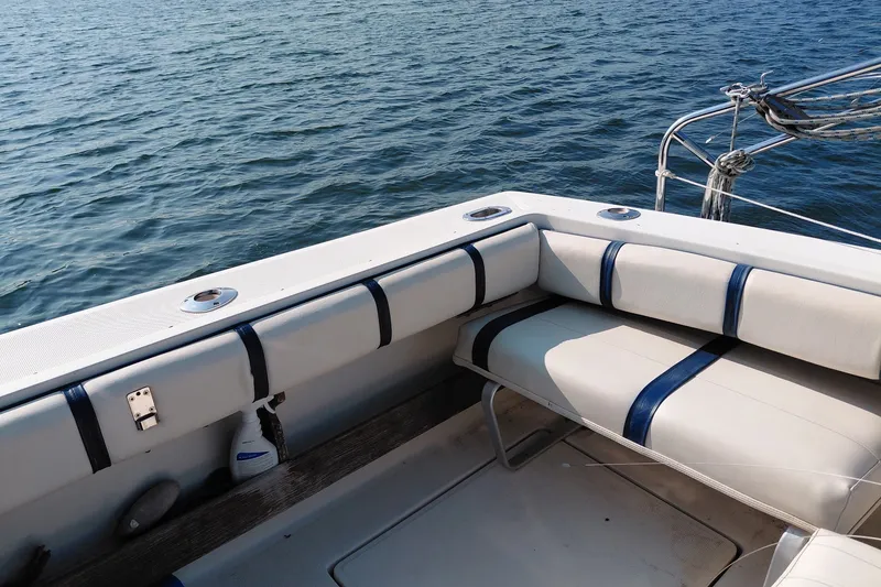 Slide: The Image of 1991 Tiara Yachts 3100 Open boat interior with cushioned seating and ocean view. - 3