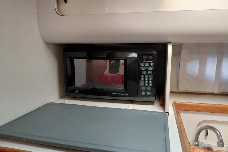 Slide: The Image of Microwave in 1991 Tiara Yachts 3100 Open galley, featuring compact design and digital controls. - 20