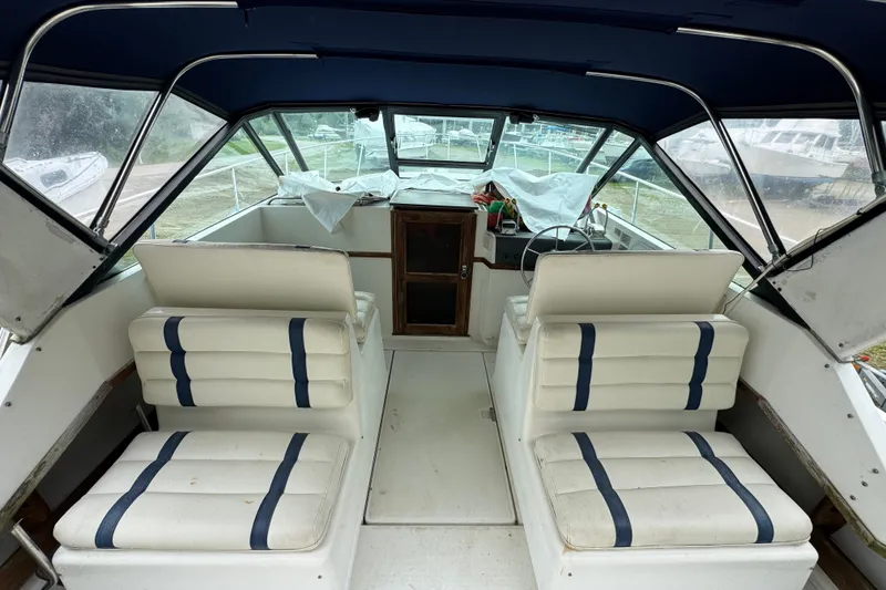 Slide: The Image of Interior of a 1991 Tiara Yachts 3100 Open, featuring white seating and helm. - 4