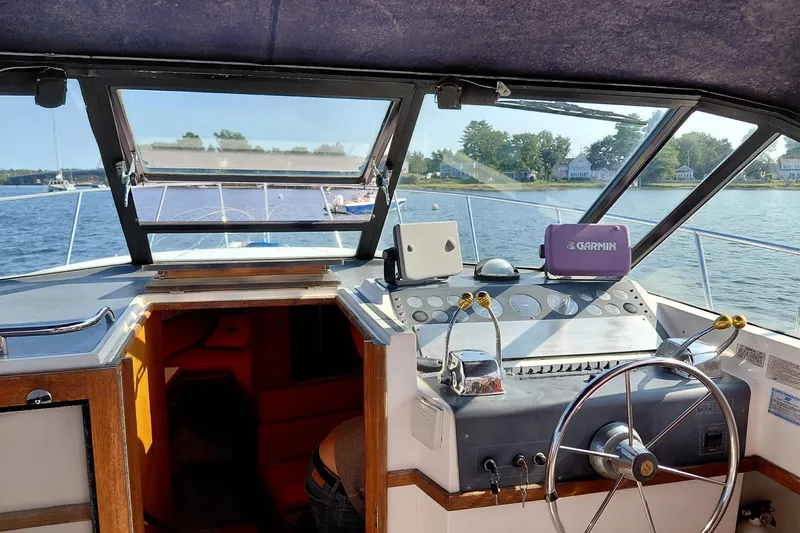 Slide: The Image of Interior view of a 1991 Tiara Yachts 3100 Open boat cockpit with Garmin navigation. - 8