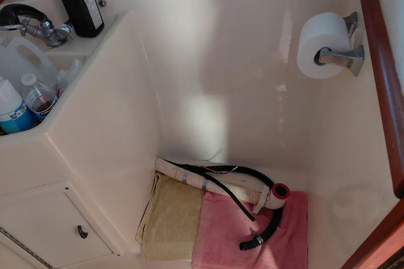 Slide: The Image of 1991 Tiara Yachts 3100 Open bathroom with sink, toiletries, and towels. - 21