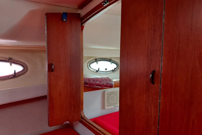Slide: The Image of Interior cabin of 1991 Tiara Yachts 3100 Open with wooden cabinets and porthole windows. - 18