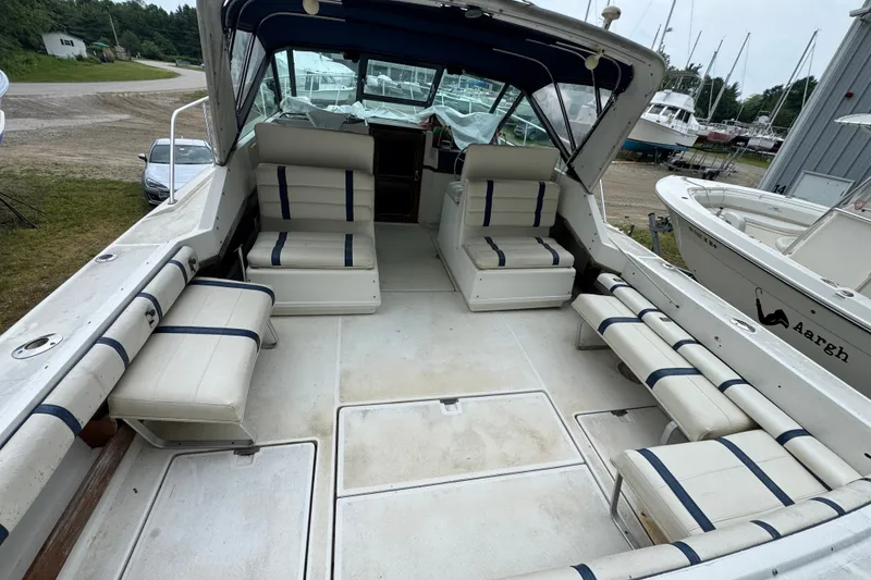 Slide: The Image of 1991 Tiara Yachts 3100 Open boat interior with cushioned seating and open deck. - 1