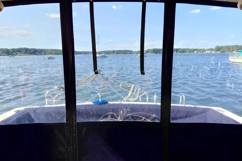 Slide: The Image of View from 1991 Tiara Yachts 3100 Open, overlooking serene lake and distant boats. - 9