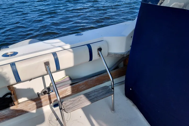 Slide: The Image of 1991 Tiara Yachts 3100 Open boat interior with seating and ocean view. - 10
