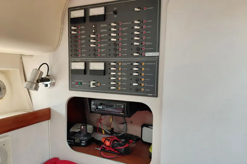 Slide: The Image of Control panel inside a 1991 Tiara Yachts 3100 Open, featuring switches and gauges. - 23