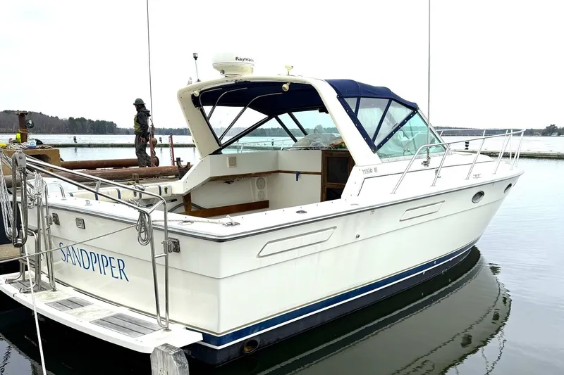 The Image of 1991 Tiara Yachts 3100 Open boat named "Sandpiper" docked at a marina. - 0